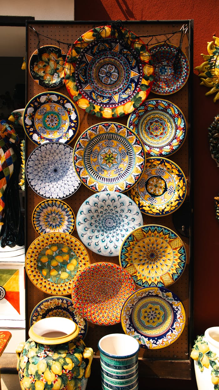 Vibrant assortment of traditional ceramic plates on display in Amalfi, Italy.